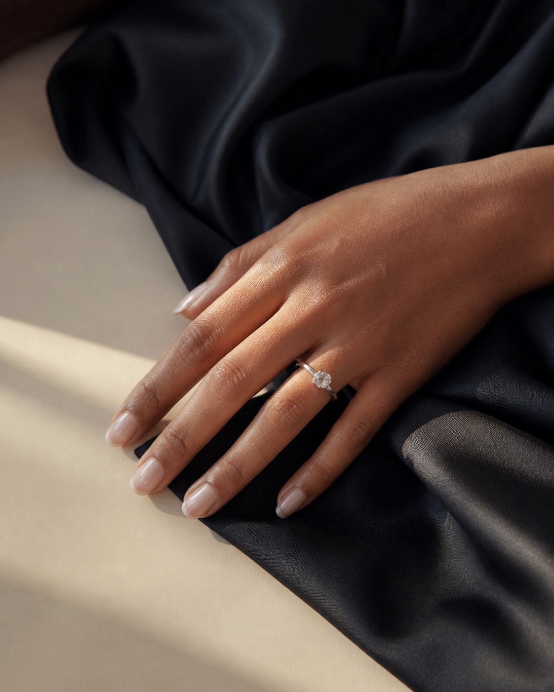 Editorial hand styling with a generic clear-stone ring impression